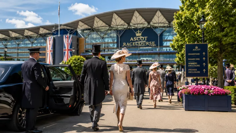 Royal Ascot racegoers arriving at Ascot Racecourse during Royal Ascot with formal dress and race day transport
